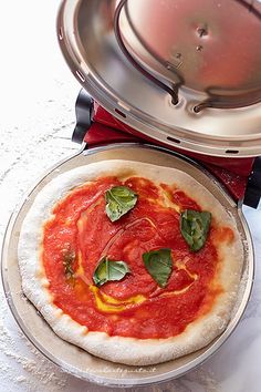 a pizza sitting on top of a pan covered in sauce