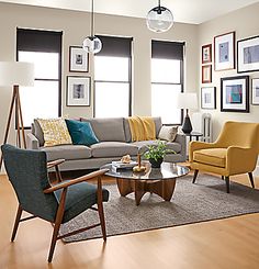 a living room filled with furniture and pictures on the wall