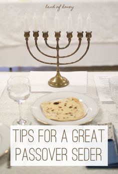 a passover dinner with a menorah and wine glasses on the table in front of it