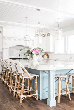 a large kitchen island with chairs around it