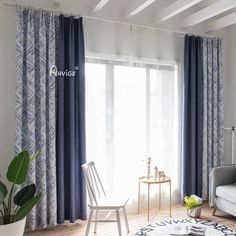 a living room with blue curtains and white furniture