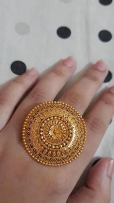 a woman's hand with a gold ring on it