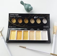 the eyeshadow palette has six different colors and is next to a small bird