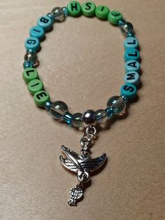 "Angling Enthusiasts can always be on board with this Fishing Scenario on a stretch beaded bracelet. Features person in a boat with a fishing pole and a live one on the line! Bracelet says \"Small fish, big lie.\" Charm is silver tone." Small Fish, Fishing Pole, On Board, The Line, Beaded Bracelet, Silver Tone, Jewelry Bracelets, Fishing, Charm Bracelet