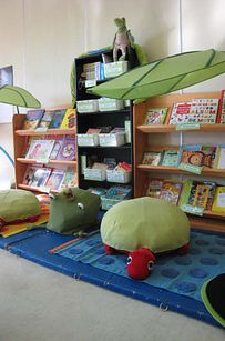 children's bookshelves and stuffed animals in a playroom at a child's book store