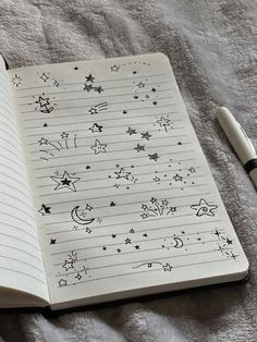 an open notebook with stars and moon drawings on it