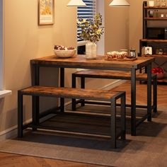 a dining room table with two benches next to it