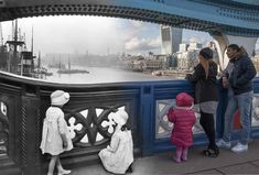 people standing on the side of a bridge looking at boats in the water and one person holding a child's hand