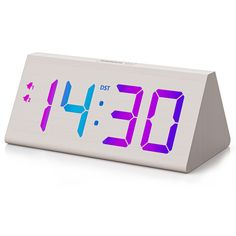 an alarm clock with the time displayed on it's display stand, in front of a white background