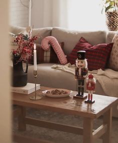 a nutcracker figurine on a coffee table in front of a couch