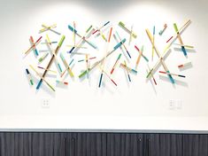 the wall is decorated with colorful sticks