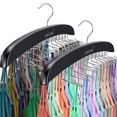 there are many different colored umbrellas hanging on the clothes rack with black hangers