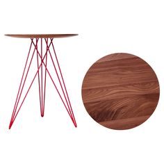 a wooden table with red metal legs and a round wood table top next to it