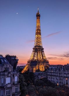 the eiffel tower lit up at night in paris, france with its lights on