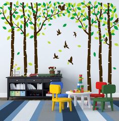 a room with trees and birds painted on the wall