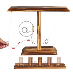 a hand is holding the string to an object that appears to be spinning on it