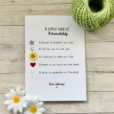 a little card of friendship with flowers next to it