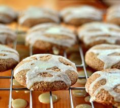 cookies with white icing sitting on a cooling rack