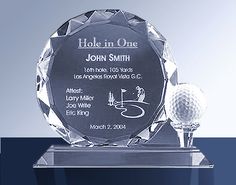 a glass trophy with a golf ball on it and the inscription hole in one is shown