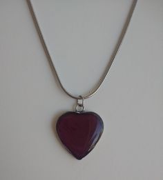 "This necklace is made with a natural red rose petal. It's been pressed, dried, and preserved in clear resin. The petal has darkened into a rich red-burgundy color. The pendant is heart shaped and measures 21mm wide by 22mm tall, not counting the loop. The chain is a snake chain that measures 22 inches long. All metal in this piece is stainless steel. Given the pendant is made with a natural rose petal, there is a chance the color may fade a little over time. Resin Jewelry Care Instructions: Mos Dark Red Necklace, Red Heart Necklace, High Aesthetic, Boho Lifestyle, Dark Jewelry, Red Rose Petals, Fall Stuff, Heart Shaped Pendant, Jewelry Care Instructions