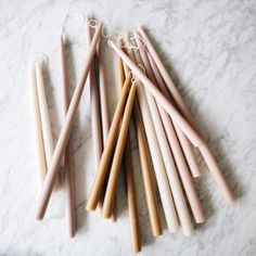 several candles are lined up on a marble surface