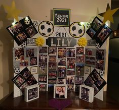 a table topped with pictures and photos next to a soccer ball on top of it