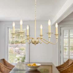 a chandelier hanging over a dining room table