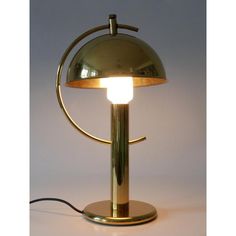 a lamp that is sitting on top of a table with a light bulb in the middle