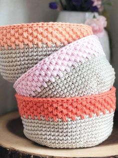 three crocheted baskets stacked on top of each other