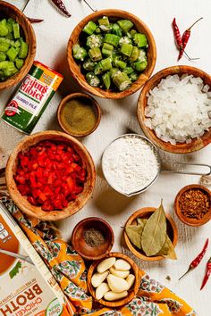 several bowls filled with different types of food on top of a table next to spices and seasonings