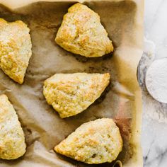 six scones sitting on top of a piece of parchment paper