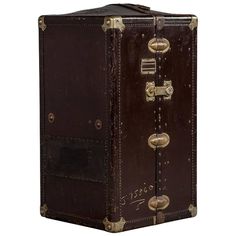 an old brown leather trunk with brass hardwares and latches on the front, isolated against a white background