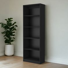 a black bookcase next to a potted plant