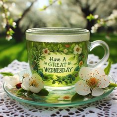 a cup and saucer sitting on top of a white doily covered tablecloth