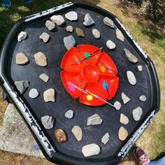 an outdoor play table with rocks and stones on it