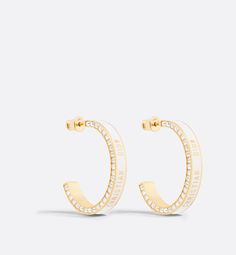 The large Dior Night Code hoop earrings offer modern and refined appeal. The Christian Dior signature adorns a gold-finish metal hoop embellished with white lacquer, while the edge features a pavé of white crystals. The earrings can be paired with other creations from the Dior Night Code line.. Hop Earrings, Dior Star, Dior Earrings, Icon Shoes, Refined Aesthetic, Jeweled Earrings, Dior Jewelry, White Crystals, Silver Cufflinks