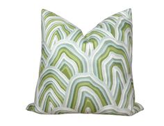 a green and white pillow with wavy lines on the front, sitting on a white background