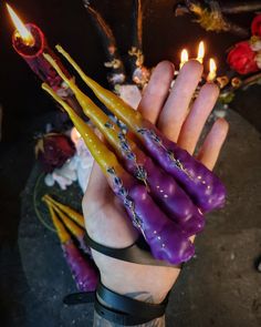 a person holding some candles in their hand