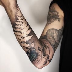 a man's arm with tattoos on it