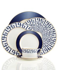 a blue and white dinner set with an intricate design