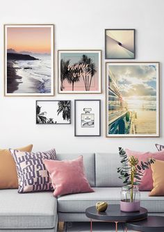 a living room filled with furniture and pictures hanging on the wall above it's coffee table