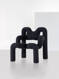 a black sculpture sitting on top of a white table