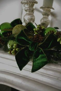 a green bow on top of a mantle