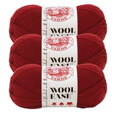 three skeins of wool yarn in red