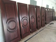 several wooden doors lined up against the wall