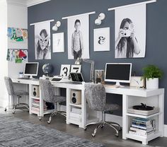 an office with two desks and several pictures on the wall above them, along with chairs