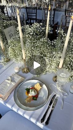 a table set for an event with candles and flowers