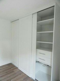 an empty room with white closets and wooden flooring is pictured in this image