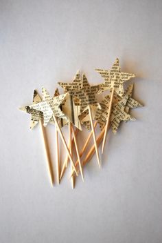 five wooden stars are arranged on toothpicks with words written in them and placed next to each other