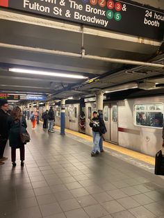 people are waiting for the subway to arrive